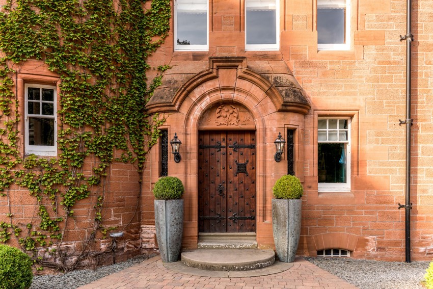 Wooden Castle Doors Surrounded by Brick With Ivy at Fonab Castle Hotel in Pitlochry ?? ''