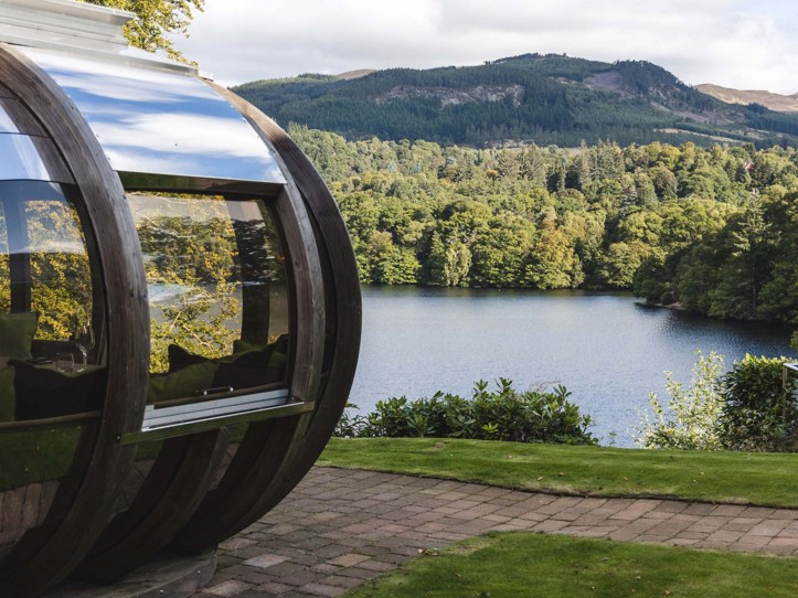 View of loch and pine trees from a dining pod at Fonab Castle Luxury Hotel Scotland  ?? ''
