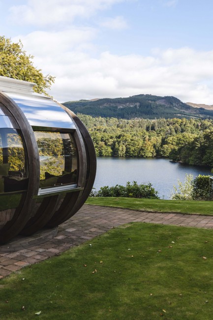 View of loch and pine trees from a dining pod at Fonab Castle Luxury Hotel Scotland  ?? ''