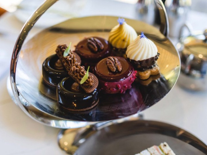 Cakes on cake stand and sandwiches during afternoon tea at luxury spa hotel in Scotland ?? ''