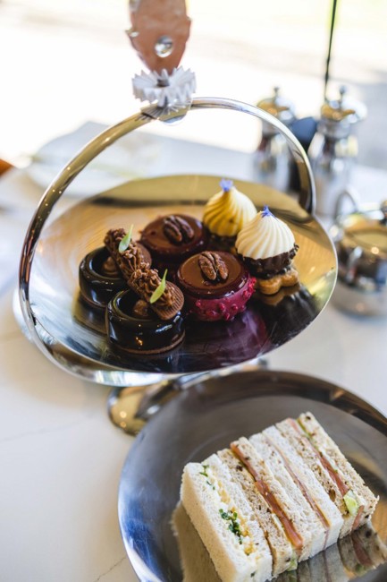 Cakes on cake stand and sandwiches during afternoon tea at luxury spa hotel in Scotland ?? ''